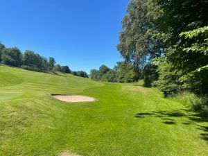 Golf course with bunker and trees